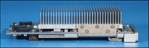 Figure 3. An air-cooled XMC module uses a highly-effective nickel-plated copper band to pull heat from a large FPGA on the underside of the board into an aluminum finned heat sink sitting in the airflow.